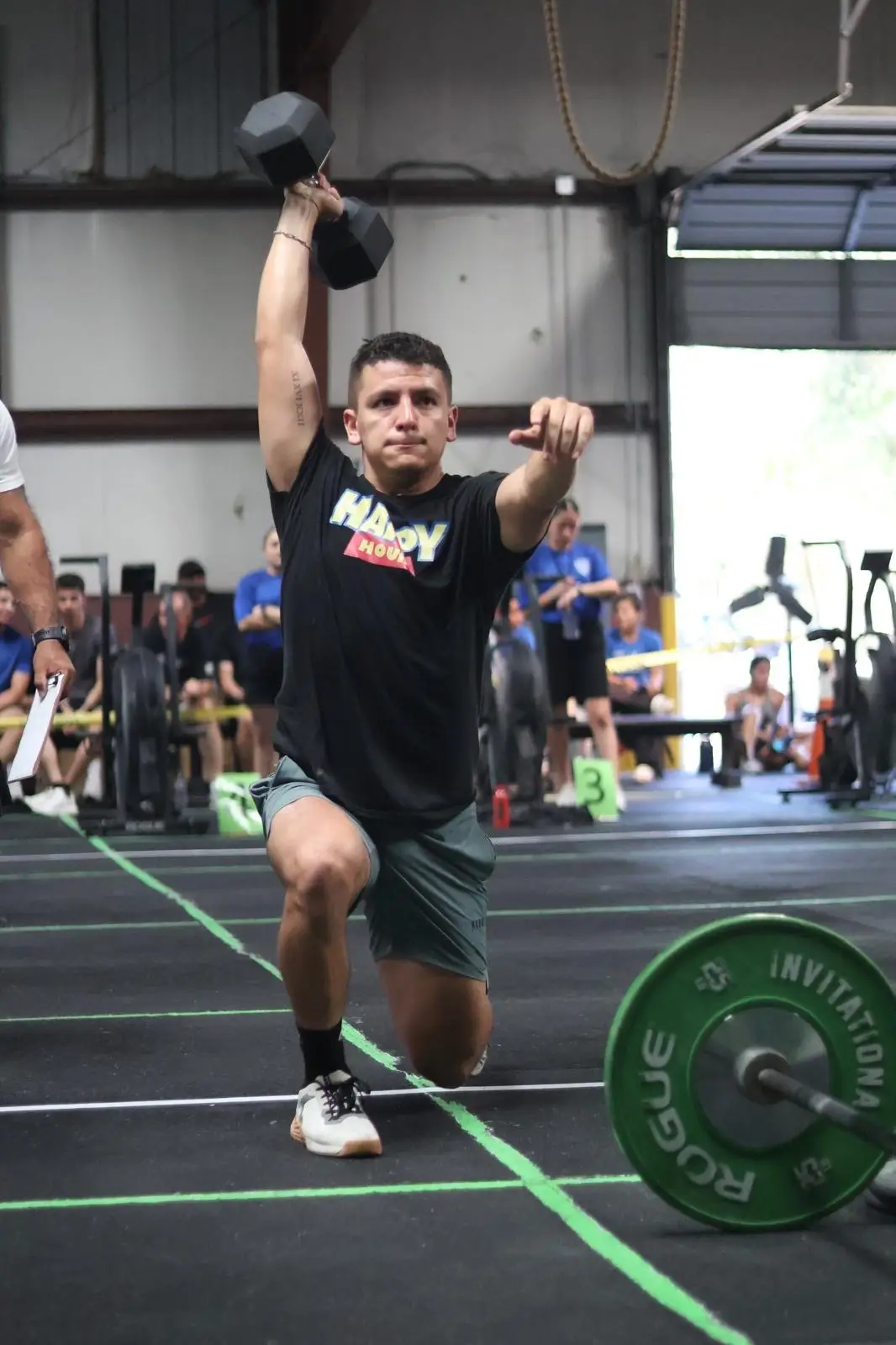 An athlete training with a barbell outside the Toxic Fitness gym