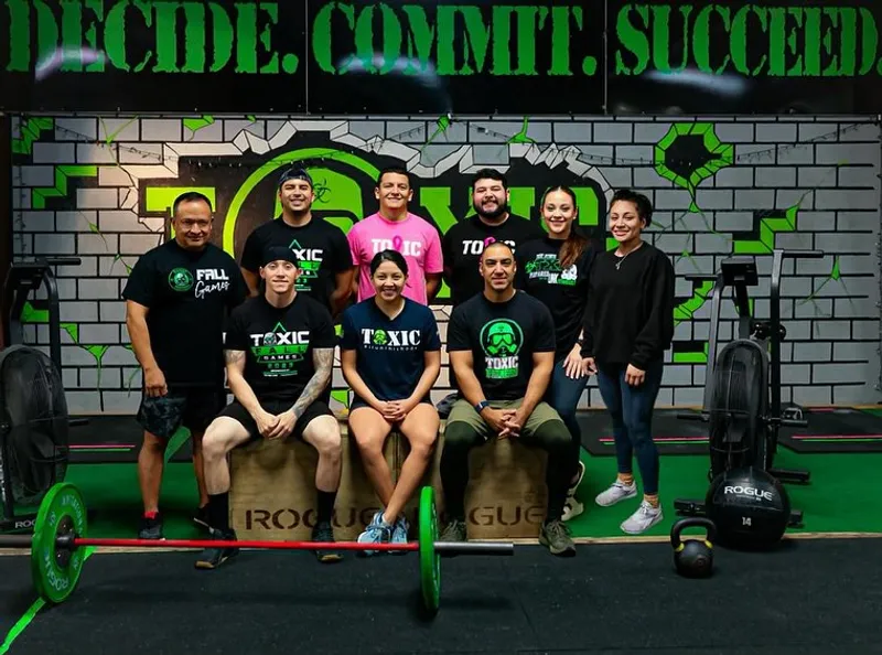 Members celebrating under the Decide Commit Succeed mural